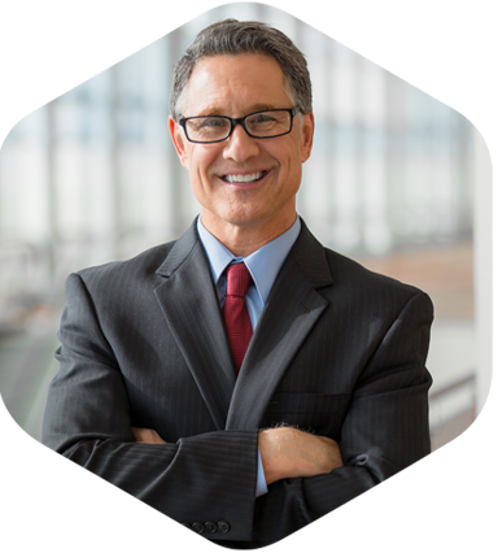 A professional man wearing a suit and tie with a pleasant expression on his face.